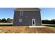 Exterior side view of a gray house with white trim at 22 Wynd Crest Way, Benson, NC 27504