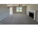 Bright, open living room with neutral carpet, a fireplace, a ceiling fan, and abundant natural light at 22 Wynd Crest Way, Benson, NC 27504
