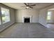 Spacious living room featuring a fireplace, neutral paint, carpet, and a ceiling fan at 22 Wynd Crest Way, Benson, NC 27504