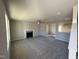 Expansive living area with fireplace, neutral walls, carpet, and a view of the adjacent kitchen at 22 Wynd Crest Way, Benson, NC 27504