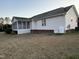 Spacious backyard featuring a screened porch, level lawn, and white siding on the home's exterior at 254 Pedernales Dr, Smithfield, NC 27577
