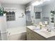 The bathroom features a double vanity, bath tub, and two windows that provide natural light at 254 Pedernales Dr, Smithfield, NC 27577