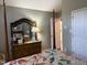 This bedroom features a four poster bed with a wood dresser and decorative mirror at 254 Pedernales Dr, Smithfield, NC 27577