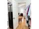 Bright bedroom featuring hardwood floors, a decorative chair, and a glimpse into a closet space at 254 Pedernales Dr, Smithfield, NC 27577