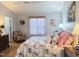 Light-filled bedroom with a floral-patterned bed, pink accents, and a sitting area at 254 Pedernales Dr, Smithfield, NC 27577