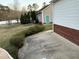 Exterior view of the home with a turquoise front door, brick accents, and well-maintained landscaping at 254 Pedernales Dr, Smithfield, NC 27577