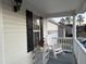 Cozy front porch with a white rocking chair, wicker table, and decorative duck, creating a welcoming entrance at 254 Pedernales Dr, Smithfield, NC 27577