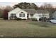 Charming single-story home featuring a well-maintained lawn, attached garage, and inviting front porch at 254 Pedernales Dr, Smithfield, NC 27577