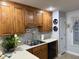 Well-lit kitchen with warm wood cabinets, white countertops, and stainless steel sink and appliances at 254 Pedernales Dr, Smithfield, NC 27577