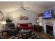 Inviting living room featuring a fireplace, plush seating, and ceiling fan at 254 Pedernales Dr, Smithfield, NC 27577