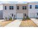 A row of townhomes each offers an attached garage, modern design, and manicured landscaping at 256 Chesapeake Commons St # 157, Garner, NC 27529