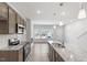 Open kitchen flows into living room and boasts stainless appliances and granite countertops at 256 Chesapeake Commons St # 157, Garner, NC 27529