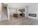Contemporary living space with luxury vinyl plank flooring, fireplace and modern kitchen at 256 Chesapeake Commons St # 157, Garner, NC 27529