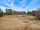 Aerial view showcasing the property's spacious yard bordered by trees, with a well-maintained lawn at 2650 Spring Hill Rd, Spring Hope, NC 27882
