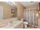 Cozy bathroom featuring a neutral color palette, a framed mirror, and a shower with patterned curtain at 2650 Spring Hill Rd, Spring Hope, NC 27882