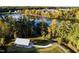 Aerial view of a community lake, green trees, a gazebo, and walking path at 268 Hank Way, Angier, NC 27501