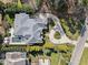 Stunning aerial view of estate featuring a pool, manicured landscaping, and a circular driveway at 2710 Cambridge Rd, Raleigh, NC 27608