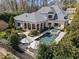 This estate features a large swimming pool and spa, expansive backyard landscaping, and outdoor patio at 2710 Cambridge Rd, Raleigh, NC 27608