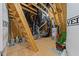 Unfinished attic featuring exposed beams, a ladder, and mechanicals at 2710 Cambridge Rd, Raleigh, NC 27608
