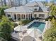 Inviting backyard showcasing pool, patio with umbrellas, and manicured landscaping of the estate at 2710 Cambridge Rd, Raleigh, NC 27608