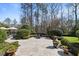 Backyard featuring a stone patio, landscaping, seating, and privacy from mature trees at 2710 Cambridge Rd, Raleigh, NC 27608