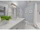 Well-lit bathroom featuring double sinks, ample counter space, and a shower/tub combination at 2710 Cambridge Rd, Raleigh, NC 27608