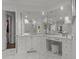 Luxurious bathroom vanity with marble countertops, custom cabinetry, large mirrors and elegant chandelier lighting at 2710 Cambridge Rd, Raleigh, NC 27608