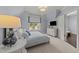 Comfortable bedroom with soft lighting, cozy bedding, and a view of the outside at 2710 Cambridge Rd, Raleigh, NC 27608