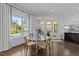 Cozy dining area with glass table, pool view, and access to outdoor living space at 2710 Cambridge Rd, Raleigh, NC 27608
