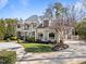 Elegant home with beautiful landscaping, circular driveway, and mature trees at 2710 Cambridge Rd, Raleigh, NC 27608