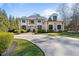 Beautiful white home showcasing elegant architecture and a lush, green lawn at 2710 Cambridge Rd, Raleigh, NC 27608