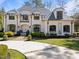 Stately white brick home featuring manicured landscaping and a circular driveway at 2710 Cambridge Rd, Raleigh, NC 27608