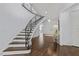 Elegant staircase leading to a bright and spacious foyer with hardwood flooring at 2710 Cambridge Rd, Raleigh, NC 27608