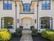 Stately home entrance with custom double doors, stone path, dark trim, and manicured landscaping at 2710 Cambridge Rd, Raleigh, NC 27608
