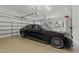 Spacious garage showcasing a luxury car, ample storage, and well-organized shelving at 2710 Cambridge Rd, Raleigh, NC 27608