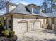 A charming two-car garage features an attached portico, garden beds, and manicured landscaping at 2710 Cambridge Rd, Raleigh, NC 27608
