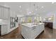 Bright kitchen with central island, modern appliances, and open floorplan to the living area at 2710 Cambridge Rd, Raleigh, NC 27608