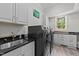 Well-equipped laundry room featuring modern appliances, sleek countertops, and ample storage at 2710 Cambridge Rd, Raleigh, NC 27608