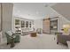 Bright living room with large windows, comfortable seating, and sliding barn door entry to flex space at 2710 Cambridge Rd, Raleigh, NC 27608