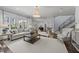 Open living room with large windows, wood floors, and seamless transition to the dining area at 2710 Cambridge Rd, Raleigh, NC 27608