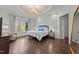 Serene bedroom boasts a decorative ceiling, large windows, and elegant furnishings at 2710 Cambridge Rd, Raleigh, NC 27608