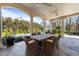 Covered outdoor dining area with a large table, seating, and views of the lush backyard at 2710 Cambridge Rd, Raleigh, NC 27608