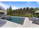 A beautiful backyard pool is surrounded by manicured landscaping and inviting lounge chairs at 2710 Cambridge Rd, Raleigh, NC 27608