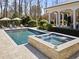 This home offers a private swimming pool with an attached spa and convenient lounge furniture at 2710 Cambridge Rd, Raleigh, NC 27608