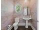Stylish powder room featuring unique patterned wallpaper and modern fixtures at 2710 Cambridge Rd, Raleigh, NC 27608