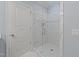 Modern glass shower featuring white tiles with accent strip and brushed hardware at 2710 Cambridge Rd, Raleigh, NC 27608