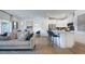 Open-concept living space with hardwood floors, a modern kitchen, and a comfortable seating area at 280 Hank Way, Angier, NC 27501