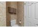 Toilet with patterned wallpaper and white door at 2820 Glenwood Gardens Ln # 101, Raleigh, NC 27608