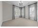 Minimalist bedroom with large windows, plantation shutters, and neutral carpeting at 2820 Glenwood Gardens Ln # 101, Raleigh, NC 27608