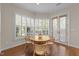 Breakfast nook with a round table, wicker chairs, and large windows with plantation shutters at 2820 Glenwood Gardens Ln # 101, Raleigh, NC 27608